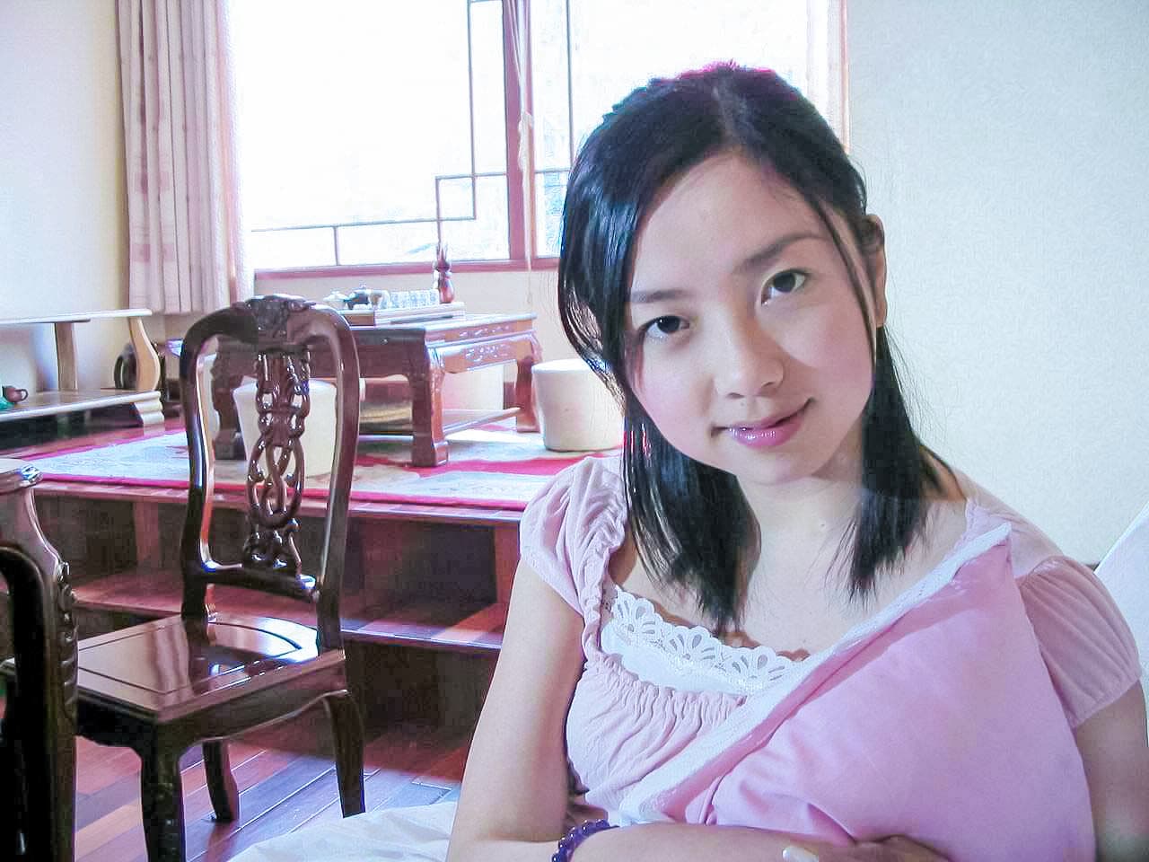 Manli balancing on elegant stiletto heels, foot arch pronounced and toes poised inside delicate straps